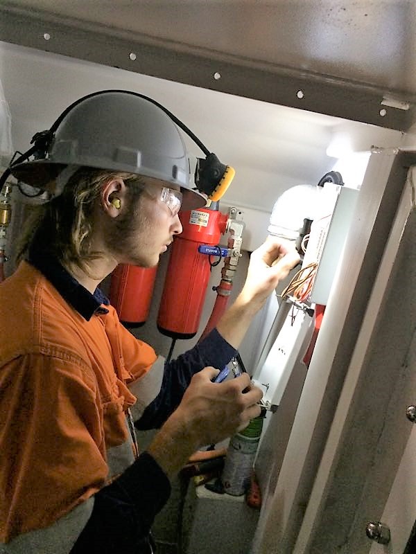 Man assembling electrical components in Bost refuge chamber.